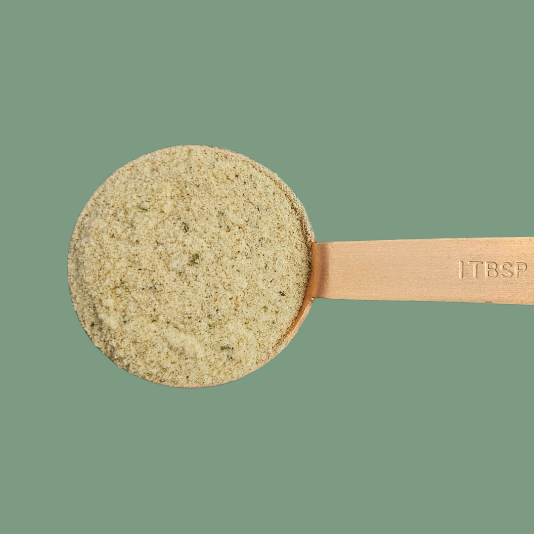 close up photo of a tablespoon measure containing the instant broth mix powder